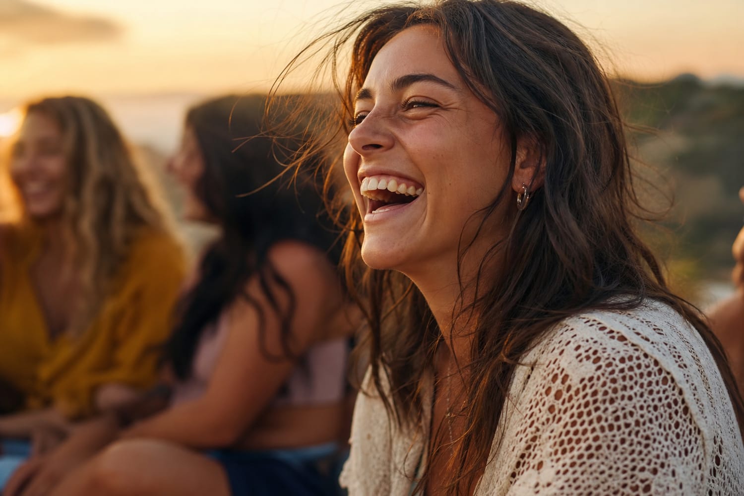 A woman laughing genuinely with friends in warm golden hour light.